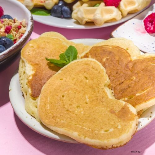 heart shaped pancakes decorated with mint leaf