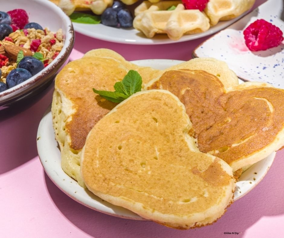 heart shaped pancakes decorated with mint leaf